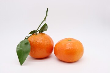 tangerines with green leaves isolated on white background