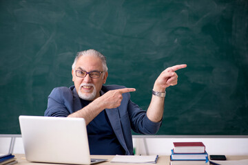 Old male teacher in the classroom