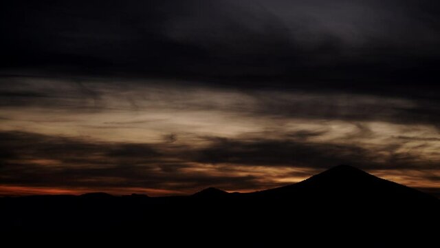 Time lapse of clouds moving over Sierra Alhamilla mountain range, Spain. Evening sunset landscape, night is falling.