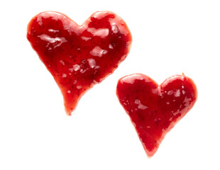 Two freehand hearts drawn of red berry jam on white