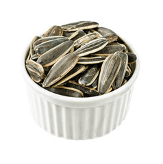 Dried Seed of Sunflower in white cup isolated on white background.