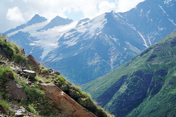 view of the mountains in the haze in the distance between two green rocks. view of the seven...
