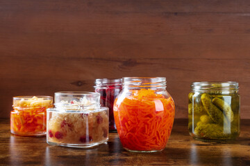 Fototapeta na wymiar Fermented, probiotic food. Canned vegetables. Pickles, sauerkraut and other organic preserves in mason jars. Healthy vegan cooking background with copy space