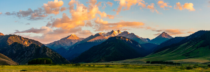 Beautiful mountain and colorful clouds natural landscape at sunset in Xinjiang,China.panoramic view.