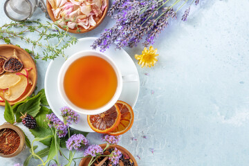 Tea, top shot with a place for text. Herbs, flowers and fruit around a cup of healthy organic hot...
