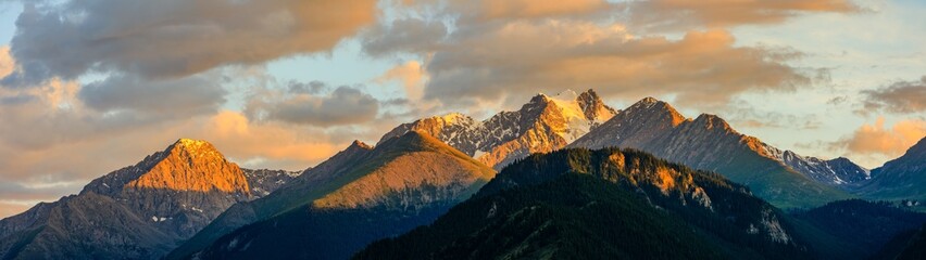 Beautiful mountain and colorful clouds natural landscape at sunset in Xinjiang,China.panoramic view.
