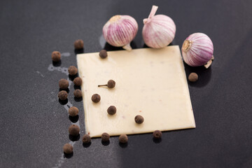 a piece of square cheese with garlic 