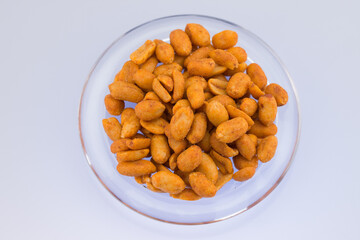 Spicy peanuts on transparent plate