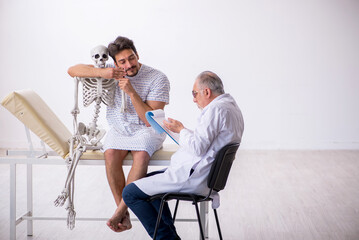Old male doctor psychiatrist examining young male patient