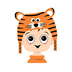 Avatar of a child with big eyes and a wide smile in a tiger hat. Cute kid with a joyful face in a festive costume for new year and Christmas. Head of adorable baby with happy emotions