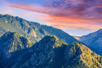 Fototapeta premium Beautiful mountain and colorful clouds natural landscape at sunset in Xinjiang,China.