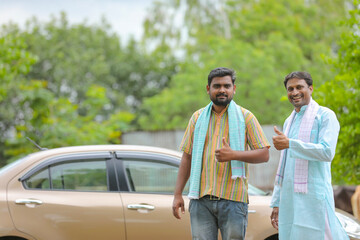 Naklejka premium Indian farmer standing with his new car