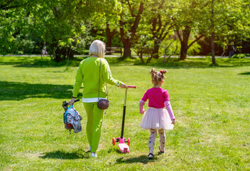 Mother with daughter walking in the city Park