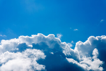 Naklejka na ściany i meble Big Clouds.bright beautiful blue sky with clouds.a big and fluffy cumulonimbus,cumulus cloud in the blue bright sky.