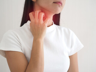 Asian woman scratching the itch on her neck with redness rash. cause of itchy skin include insect...