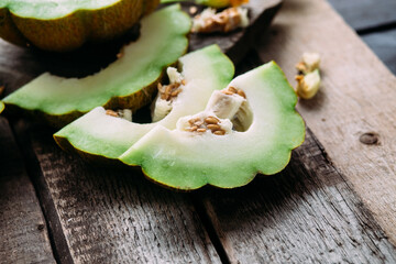 Ripe melon on wooden background close up