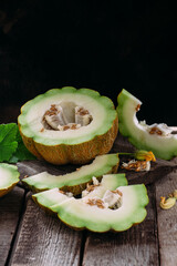 Ripe melon on wooden background close up