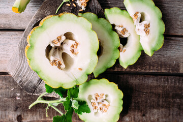 Ripe melon on wooden background close up