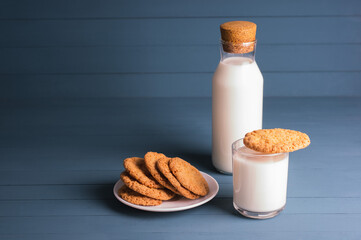 Fresh baked butter cookies with milk. Homemade oven cookies on a blue wooden background.
