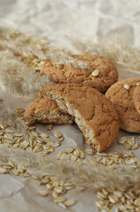 oatmeal cookies and oats on a brown background