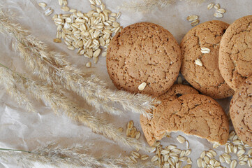 oatmeal cookies and oats on a brown background