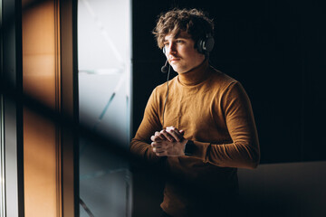 Man with earphones at a radio station