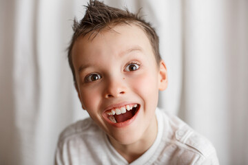 Home portrait of a little boy looking at the camera. Interesting look. Surprise on the face. To be surprised 