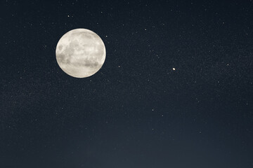 Fototapeta na wymiar Huge full moon on the night sky with bright stars