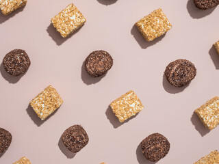 The brown and white Turkish delight lies diagonally in a row on a powdery background. Traditional oriental dessert. View from above. Flat lay.