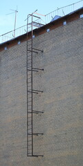 Fototapeta premium Metal fire escape on a brick wall