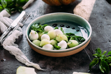 Caprese salad with melon, mozzarella and balsamic sauce. Food styling