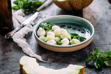Caprese salad with melon, mozzarella and balsamic sauce. Food styling