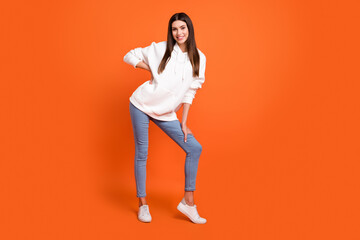Fototapeta na wymiar Full length body size view of attractive cheerful thin girl posing good mood isolated over bright orange color background