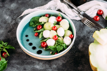 Caprese salad with melon, mozzarella and balsamic sauce. Food styling