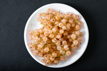 White currant in a bowl on a gray background. Close up.