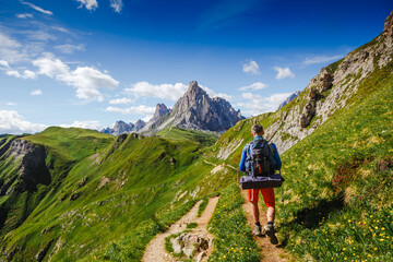 Caucasian male hiker walking through mountains. Travel Lifestyle wanderlust adventure concept...