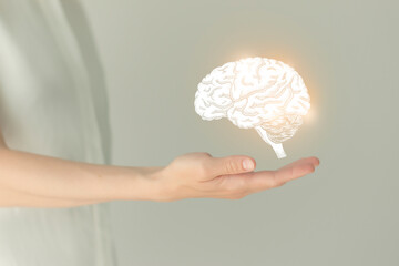Woman in white clothes holding virtual brain in hand. Handrawn human organ, detox and healthcare,...