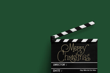 Fototapeta premium Merry Christmas, Handwriting on film slate.Green background.