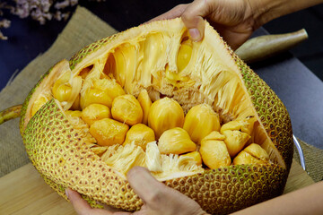 organic ripe chempedak fruit peeling to eat on table