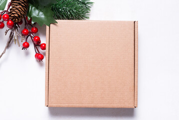 Brown cardboard mailer box decorated with Christmas ornaments