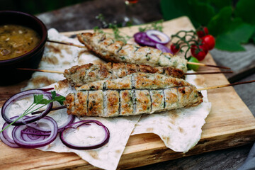 Lula kebab on pita bread with vegetables