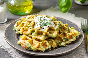 Homemade zucchini waffles in a plate on a culinary background closeup