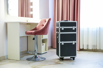 make up artist trolley case is in dressing room near the vanity mirror 
