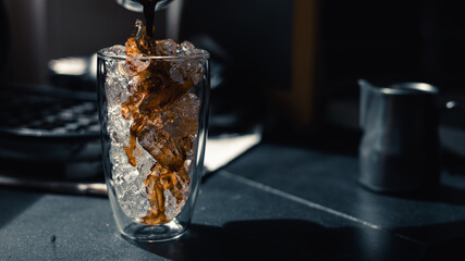 Close-up of iced coffee served on black table at cafe​