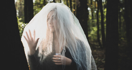 Gothic bride at forest. Halloween party and masquerade ideas, people outfit.  