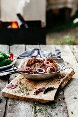 Marinated pork for shish kebab in an iron micron. Raw meat