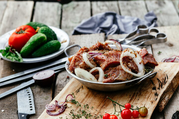 Marinated pork for shish kebab in an iron micron. Raw meat