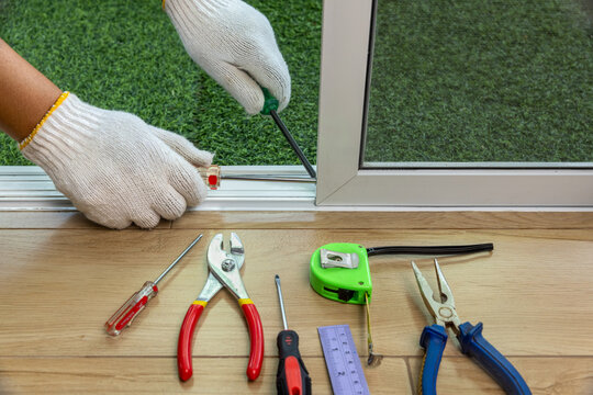 Worker Fixing The Insect Screen Sliding Door