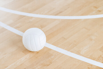 Volleyball ball and white line on wooden court. Horizontal education and sport poster, greeting cards, headers, website