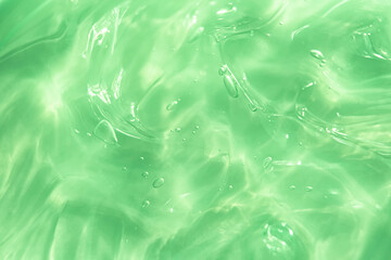 Green water Aloe Vera gel smudged texture. Abstract clear cosmetic cream, face serum, moisturizer...